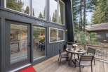 Experience mountain living at its finest with this stunning A-frame home, featuring a modern dark exterior and expansive windows that invite the surrounding forest indoors.