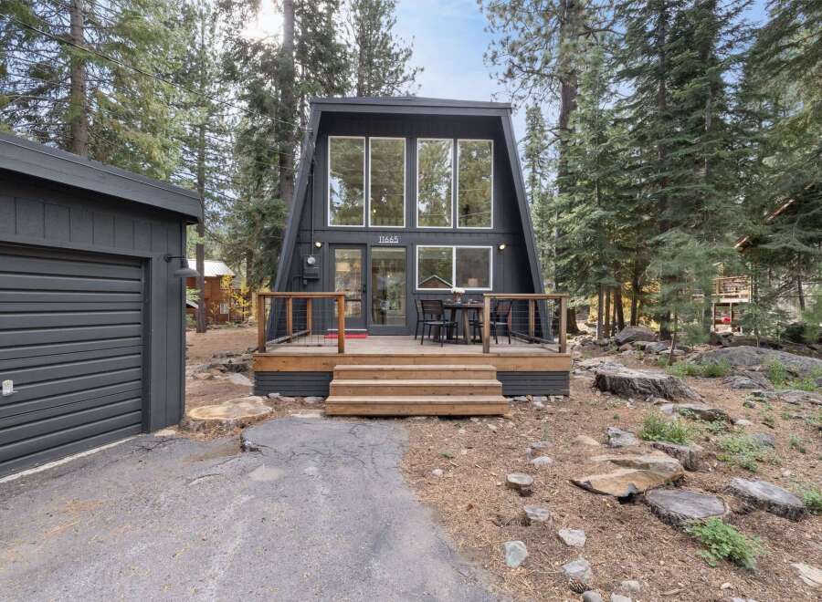 Experience modern A-frame living in this stunning black cabin nestled amongst tall pine trees.