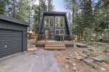Experience modern A-frame living in this stunning black cabin nestled amongst tall pine trees.