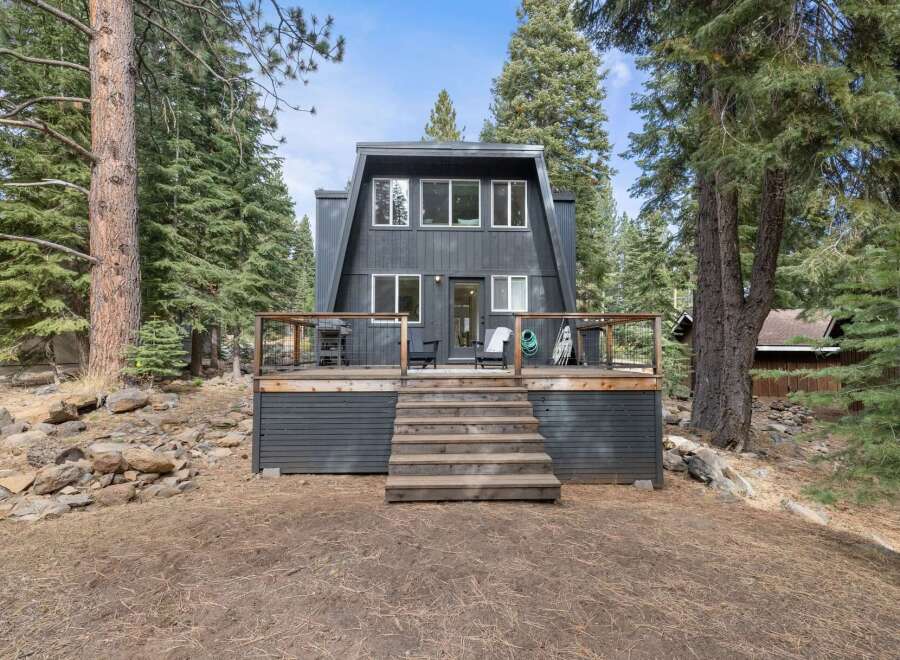 Embrace the mountain lifestyle in this charming A-frame home nestled amongst towering pine trees.