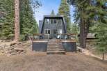 Embrace the mountain lifestyle in this charming A-frame home nestled amongst towering pine trees.