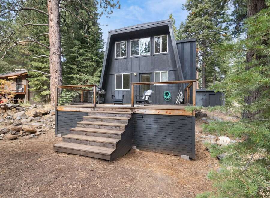 Experience the charm of this A-frame cabin nestled among tall pine trees.