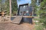 Experience the charm of this A-frame cabin nestled among tall pine trees.