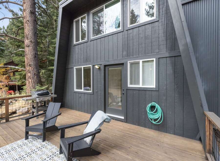 Enjoy outdoor living on this spacious wooden deck, perfect for entertaining or relaxing.