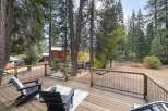 Enjoy the serene mountain lifestyle from this spacious deck, perfect for outdoor entertaining or quiet relaxation amidst the tall pines.