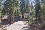 Discover this modern A-frame home nestled amongst tall pine trees, offering a unique architectural style and a serene natural setting.