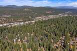 Nestled amidst a dense forest of towering pine trees, this property offers a secluded mountain retreat.