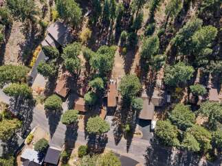 Discover this charming property nestled amongst mature trees, offering a serene and private retreat.
