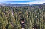 Discover this charming home nestled within a dense forest of mature pine trees, offering unparalleled privacy and a serene natural setting.
