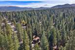 Nestled amidst a dense forest of towering pine trees, this property offers a serene and private retreat.