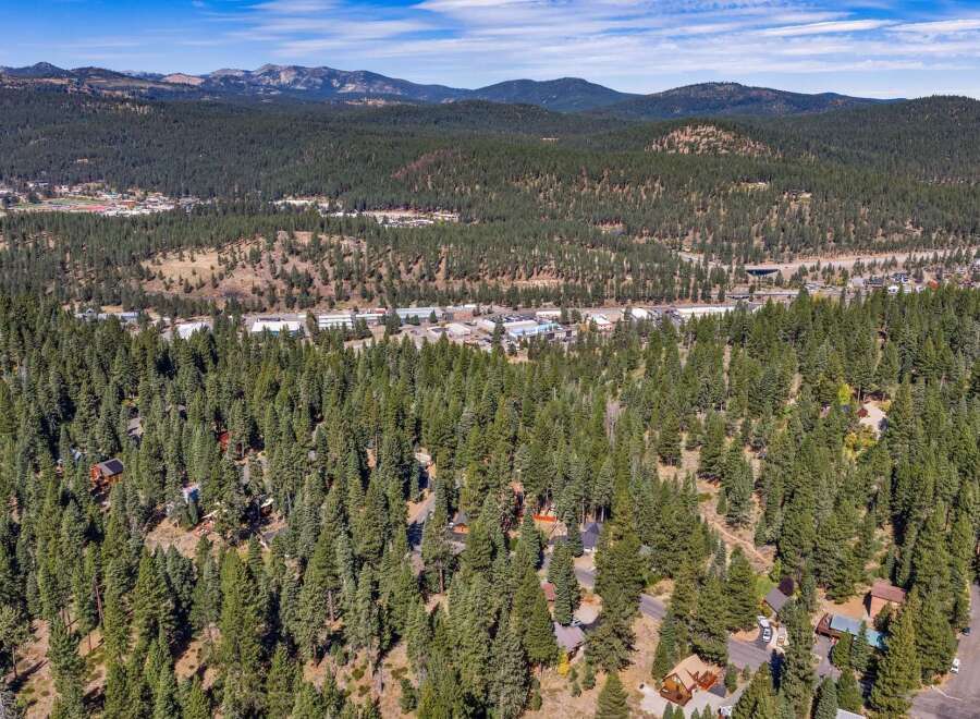 Nestled amidst a dense forest of towering pine trees, this property offers a serene and private mountain retreat.