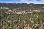 Nestled amidst a dense forest of towering pine trees, this property offers a serene and private mountain retreat.