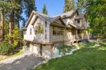 Nestled amidst tall pine trees, this stunning multi-story home offers a picturesque retreat.