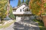 Nestled amidst mature trees with vibrant autumn foliage, this charming home offers a picturesque setting.