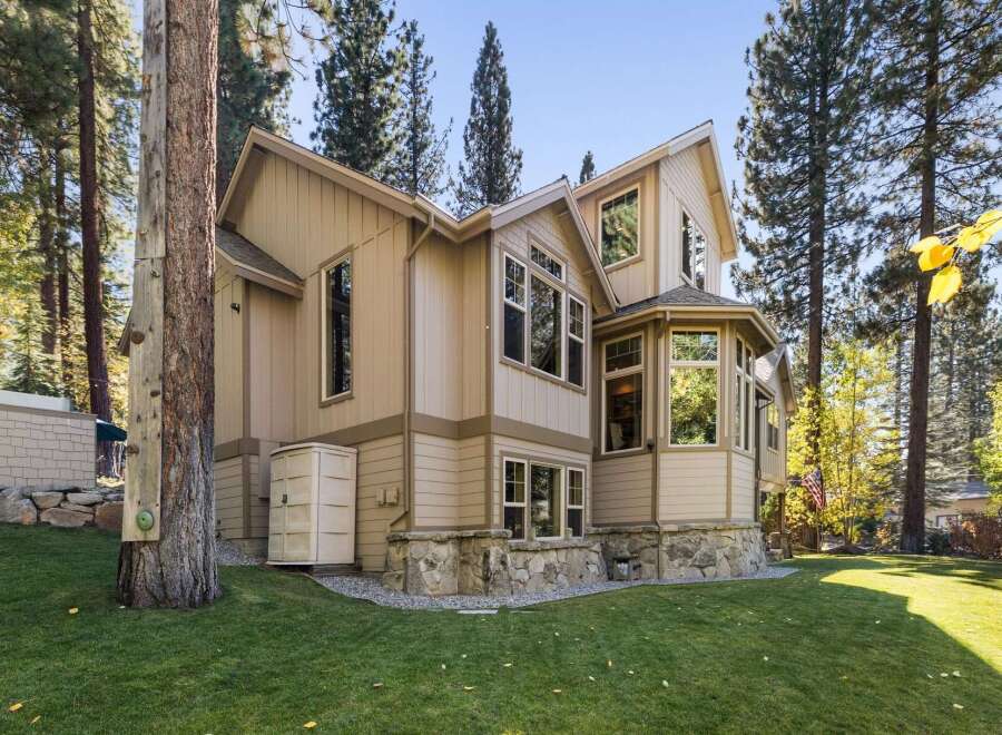 Nestled amongst tall pine trees, this charming home offers a unique blend of rustic and modern living.