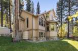 Nestled amongst tall pine trees, this charming home offers a unique blend of rustic and modern living.
