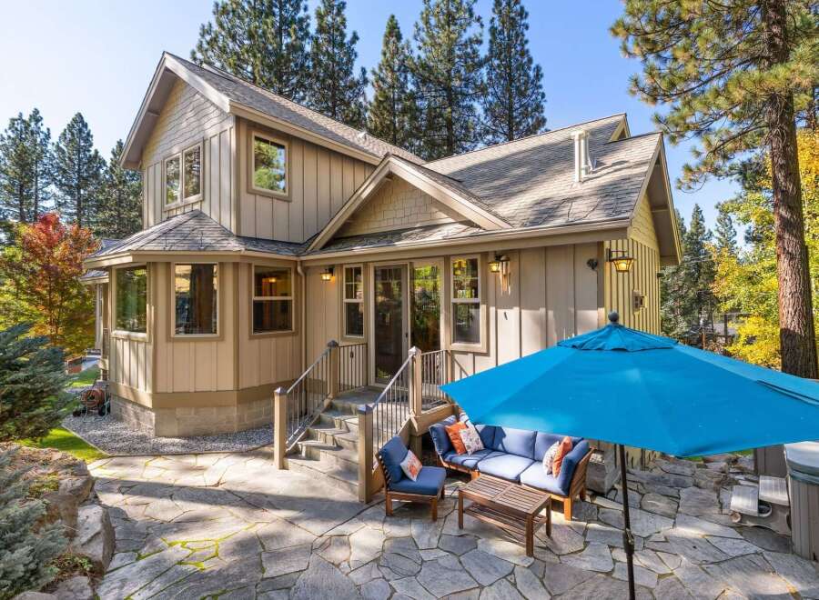 Enjoy outdoor living with this charming home featuring a spacious stone patio, perfect for entertaining.