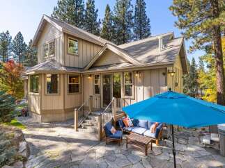 Enjoy outdoor living with this charming home featuring a spacious stone patio, perfect for entertaining.
