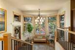 Step into this inviting entryway featuring a beautiful bay window that floods the space with natural light, offering picturesque views of the surrounding autumn foliage.
