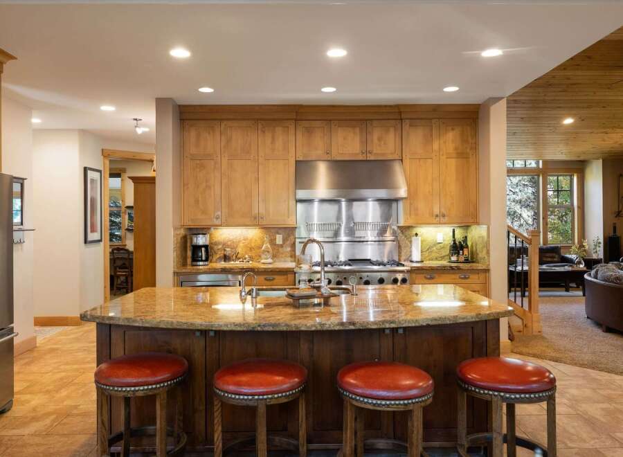 This spacious kitchen boasts custom wood cabinetry and a large granite island, perfect for entertaining.