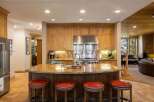 This spacious kitchen boasts custom wood cabinetry and a large granite island, perfect for entertaining.