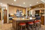 This spacious kitchen boasts a large granite island with comfortable seating, perfect for casual dining or entertaining guests.