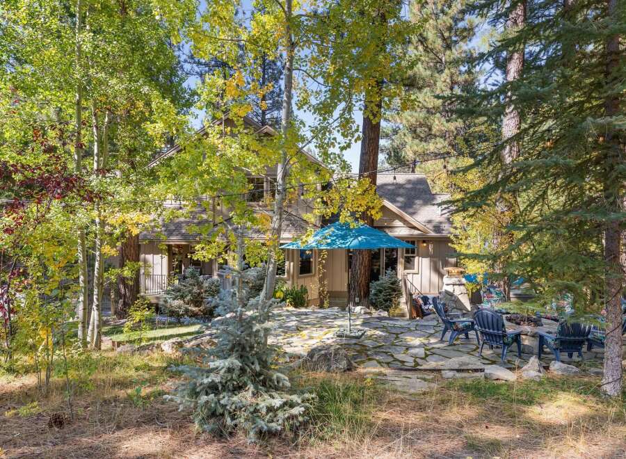 Nestled amongst vibrant autumn foliage, this charming home offers a serene escape.