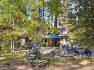 Nestled amongst vibrant autumn foliage, this charming home offers a serene escape.