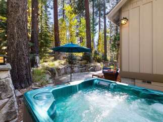 Relax and unwind in this luxurious hot tub, perfectly situated amidst a serene forest setting.