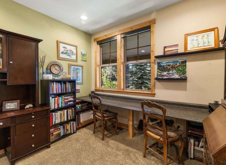 Discover a charming home office space featuring a built-in desk with ample workspace, perfect for productivity.