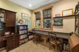 Discover a charming home office space featuring a built-in desk with ample workspace, perfect for productivity.