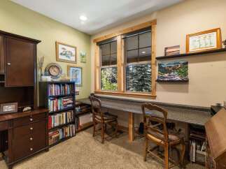 Discover a charming home office space featuring a built-in desk with ample workspace, perfect for productivity.