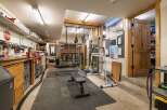 This versatile space offers a dedicated home gym area complete with a weight bench, resistance bands, and a ski training machine, perfect for maintaining an active lifestyle.