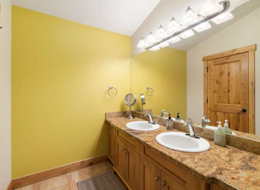 This bathroom features a bright yellow accent wall, creating a vibrant and cheerful atmosphere.