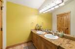 This bathroom features a bright yellow accent wall, creating a vibrant and cheerful atmosphere.