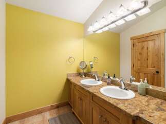 This bathroom features a bright yellow accent wall, creating a vibrant and cheerful atmosphere.