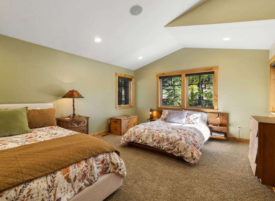 This charming bedroom features two comfortable beds, perfect for families or guests.