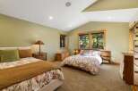 This charming bedroom features two comfortable beds, perfect for families or guests.