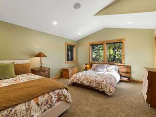 This charming bedroom features two comfortable beds, perfect for families or guests.