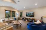 This cozy living room features a large, comfortable sectional sofa and a unique, round wooden coffee table, perfect for gathering.
