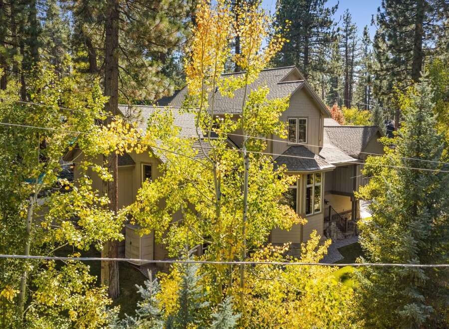 Nestled amidst a vibrant autumn forest, this charming home offers a serene retreat.