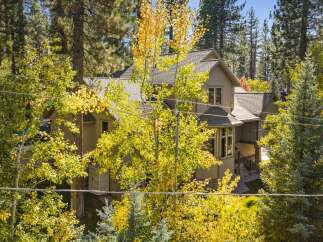 Nestled amidst a vibrant autumn forest, this charming home offers a serene retreat.