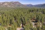 Nestled amidst a dense forest of towering pine trees, this property offers a serene and private retreat.