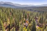 Nestled amidst a dense forest of towering pine trees, this stunning property offers a serene and private retreat.