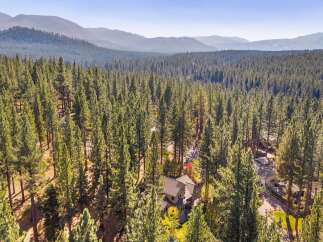 Nestled amidst a dense forest of towering pine trees, this stunning property offers a serene and private retreat.