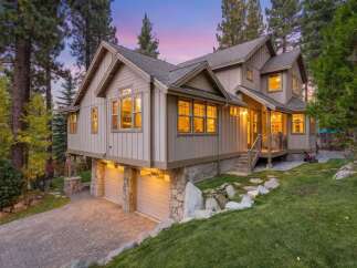 Nestled amidst tall pine trees, this stunning mountain home offers a serene retreat.