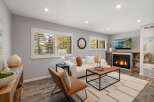 Step into this inviting living room, featuring a cozy fireplace and a large TV for entertainment.