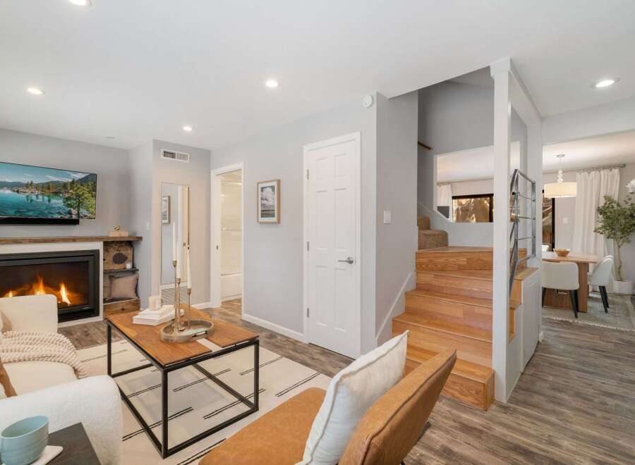 Step into this inviting living space featuring a cozy fireplace and a large flat-screen TV, perfect for relaxing evenings.