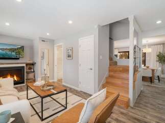 Step into this inviting living space featuring a cozy fireplace and a large flat-screen TV, perfect for relaxing evenings.