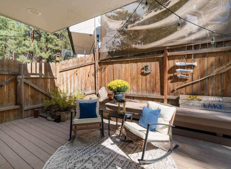 Enjoy outdoor living on this charming deck, perfect for relaxing or entertaining.